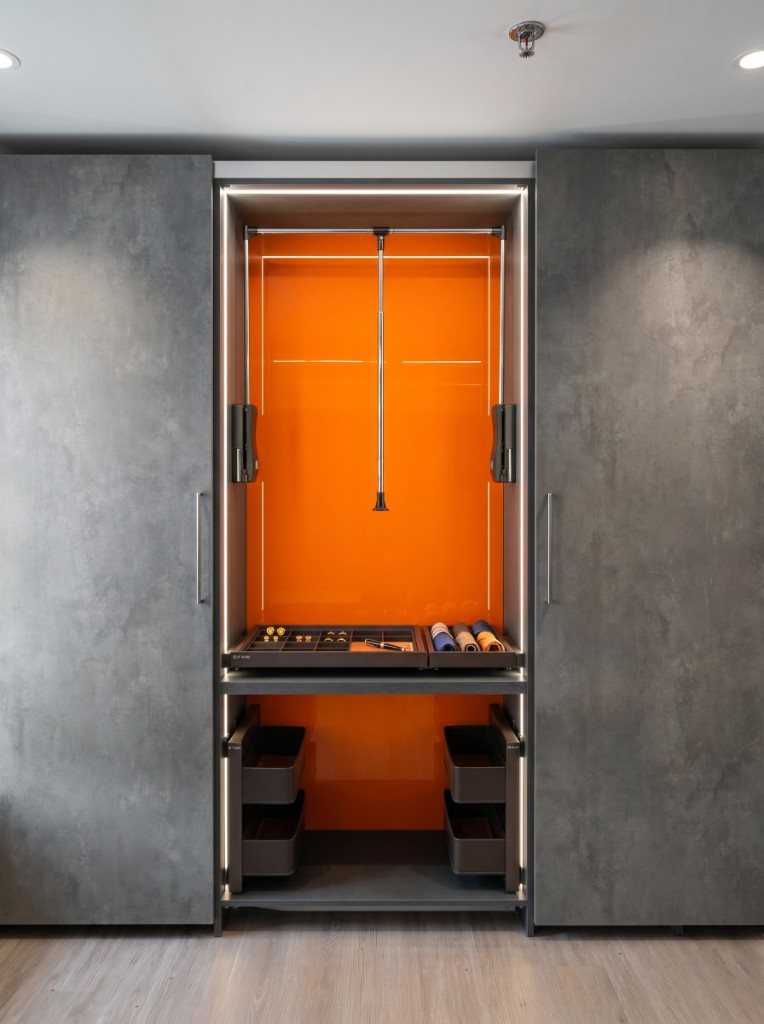 Custom closet interior with pull-down rod and accessory trays