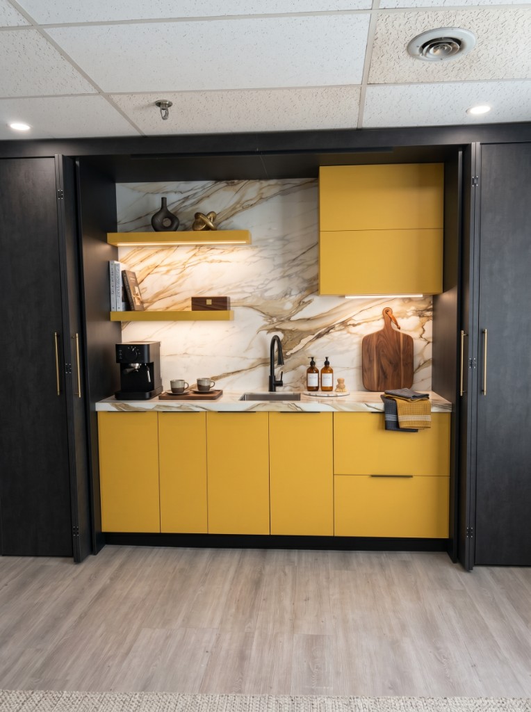 Built-in coffee bar with marble backsplash and mustard cabinetry